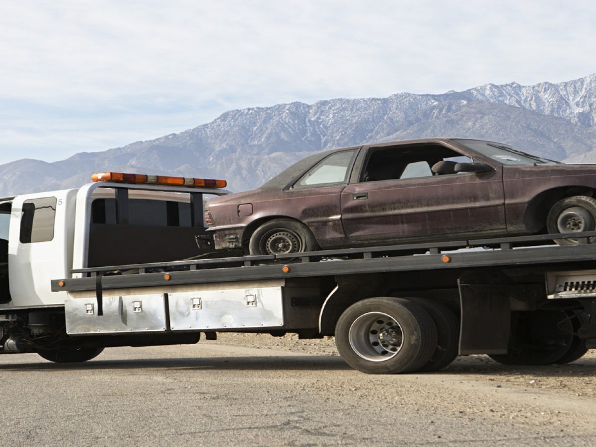 Broken car on tow truck